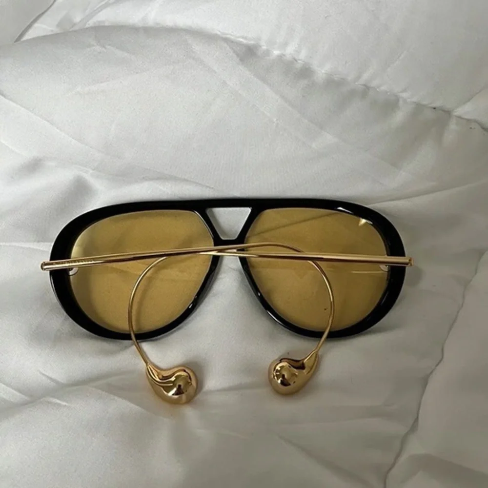 Bottega Veneta Black Frame Sunglasses with Yellow Lenses